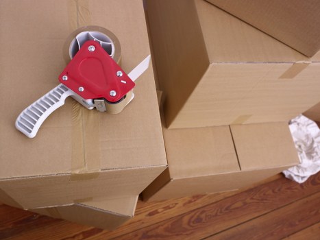 Packed boxes and furniture ready for transport by van