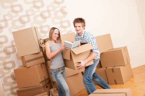 Local movers organising packed boxes for transport in Uxbridge